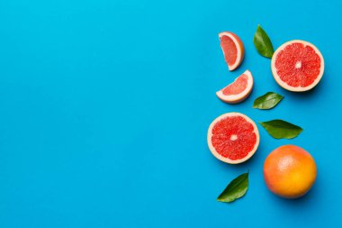 Renkli arka planda sulu greyfurt dilimli taze meyve greyfurdu. Üst Manzara. Uzayı kopyala yaratıcı yaz konsepti. Minimum düzlükte turunçgillerin yarısı kopyalama alanı ile yatar.