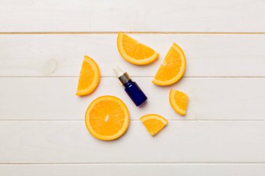 Portakal meyveli şişeler ahşap arka planda gerekli yağ. Kopyalama alanı olan alternatif tıp üst görünümü.