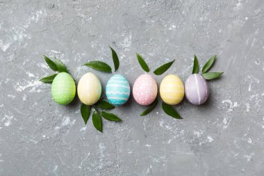 Beyaz arka planda yay yaprağı olan renkli Paskalya yumurtaları. Renkli Yumurta Tatil Kenarı.