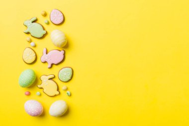 bayram hazırlığı renkli arka planda kurabiyeli çok renkli Paskalya yumurtaları. Pastel renginde Paskalya yumurtası. Kopyalama alanı olan tatil kavramı.
