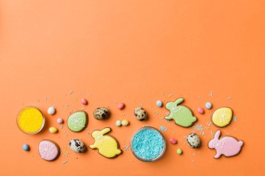 bayram hazırlığı renkli arka planda kurabiyeli çok renkli Paskalya yumurtaları. Pastel renginde Paskalya yumurtası. Kopyalama alanı olan tatil kavramı.