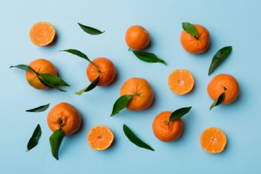 Renkli arka plan olarak birçok taze olgun Mandarin, üst görünüm. Mandalina ve mandalina dilimlerinin zarif arkaplanı Üst görünüm düz yatıyordu.