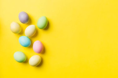 Bayram hazırlığı. Renkli arka planda Paskalya yumurtaları. Pastel renginde Paskalya yumurtası. Kopyalama alanı olan tatil kavramı.