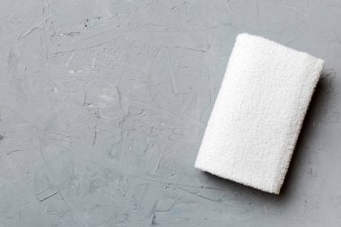 Renkli arkaplanda kopyalama alanı olan beyaz havluların üst görünümü.