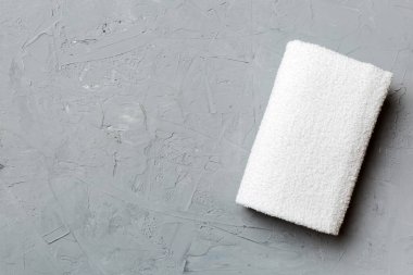 Renkli arkaplanda kopyalama alanı olan beyaz havluların üst görünümü.