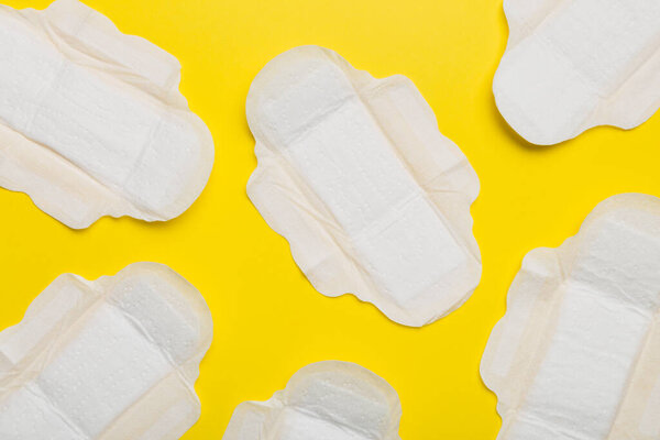 Women hygiene products or sanitary pad on colored background. Pastel color. Closeup. Empty place for text. Female daily hygiene.