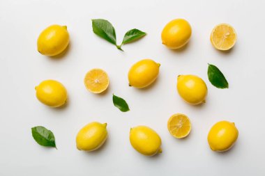 Renkli arka plan olarak pek çok taze limon, üst manzara. Limon ve limon dilimlerinin zarif arka planı Üst görünüm düz yatıyordu.