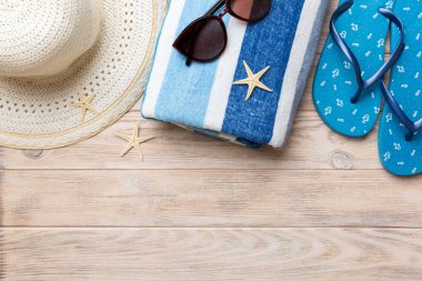 Yaz tatili konsepti düzdü. Hasır şapka plaj aksesuarları ve havlunun üstü. Mesaj için yer var. seyahat kavramı.