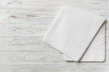 Renkli arkaplanda kopyalama alanı olan beyaz havluların üst görünümü.