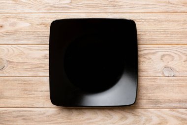 Ahşap zemin üzerinde boş kare plakanın üst görünümü. Tasarımın için boş boşluk.