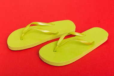 Beach accessories. Flip flops and starfish on colored background. Top view Mock up with copy space.
