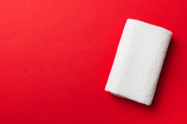 Renkli arkaplanda kopyalama alanı olan beyaz havluların üst görünümü.