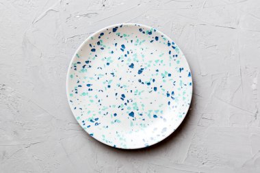 Ahşap zemindeki boş renkli tabağın üst görünümü. Tasarımın için boş boşluk.