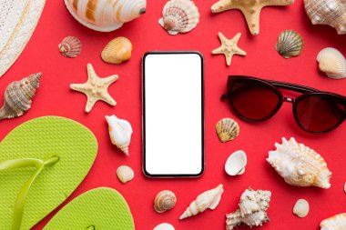 Renkli arka planda telefon ve plaj aksesuarları olan düz kompozisyon. Boş ekran ile akıllı telefon kopyalama alanı ile taklit.