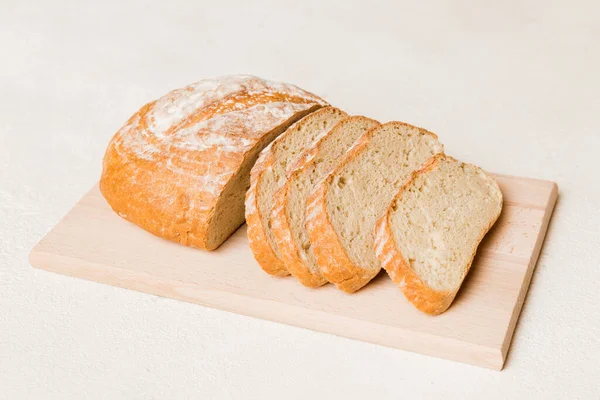 Assortment of freshly sliced baked bread with napkin on rustic table top view. Healthy unleavened bread. French bread slice.