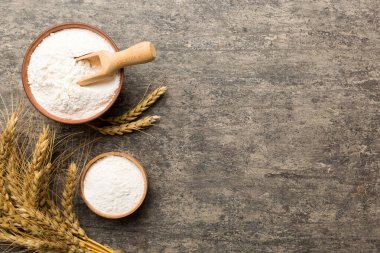 Tahta kasede buğday unu ve renkli arka planda buğday dikenleri. dünya buğday krizi.