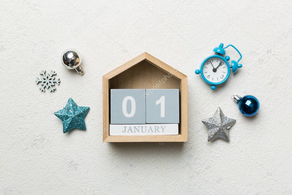 Christmas wood calendar with new year decorations, aganist colored background. Christmas calendar 1 january.