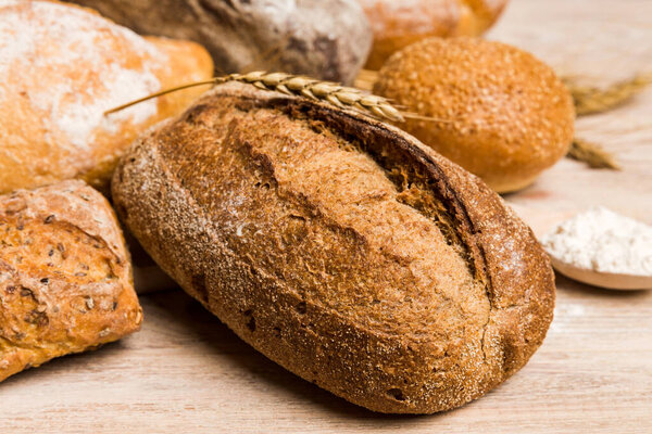 Homemade natural breads. Different kinds of fresh bread as background, perspective view with copy space.