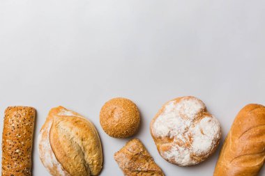 Ev yapımı doğal ekmek. Arka plan olarak farklı taze ekmek türleri, kopya alanı ile üst görünüm.