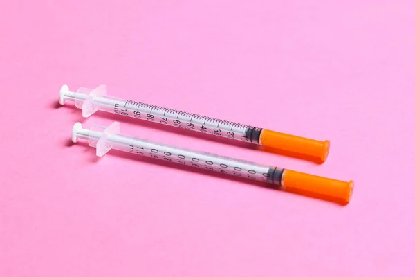Top view of insulin syringes ready for injection on colorful background. Diabetic concept with copy space.