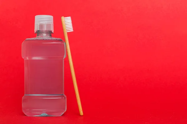 Mouthwash and other oral hygiene products on colored table top view with copy space. Flat lay. Dental hygiene. Oral care products and space for text on light background. concept.