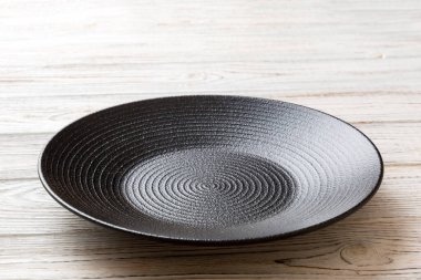 Ahşap zemindeki boş siyah plakanın perspektif görüntüsü. Tasarımın için boş boşluk.