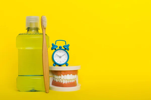 Mouthwash and other oral hygiene products on colored table top view with copy space. Flat lay. Dental hygiene. Oral care products and space for text on light background. concept.