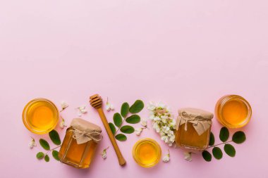 Akasya çiçekli ve yapraklı bal kavanozu. Taze bal üst görünüm düz yatıyordu.