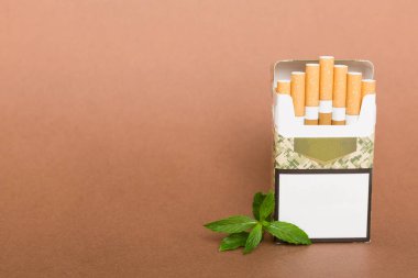 Bir paket mentollü sigara ve renkli masada taze nane şekeri, mentollü sigaralar düz yerde yatıyordu..