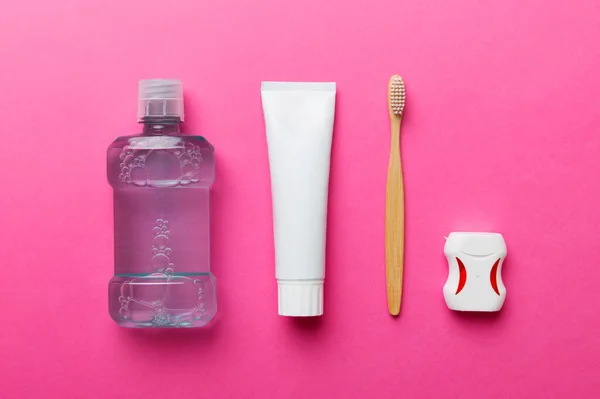 Mouthwash and other oral hygiene products on colored table top view with copy space. Flat lay. Dental hygiene. Oral care products and space for text on light background. concept.