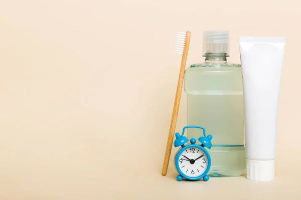 Mouthwash and other oral hygiene products on colored table top view with copy space. Flat lay. Dental hygiene. Oral care products and space for text on light background. concept.