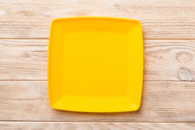 Ahşap zemin üzerinde boş kare plakanın üst görünümü. Tasarımın için boş boşluk.