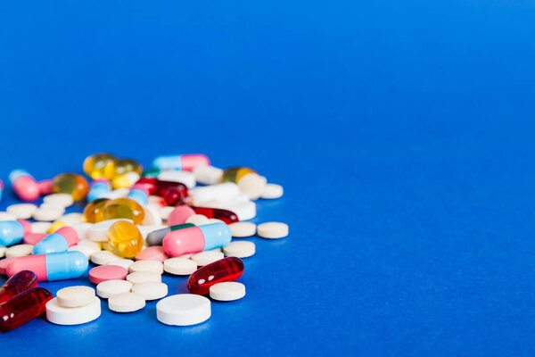 Many different colorful medication and pills perspective view. Set of many pills on colored background.