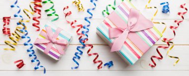 Renkli kağıda sarılı ve renkli arka planda konfetiyle süslenmiş hediye kutularıyla tatil dairesi yatıyordu. Noel, Doğum günü, Sevgililer Günü ve satış konsepti, üst manzara.