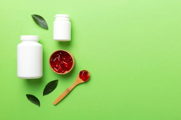 different drugs and health supplement pills with medicine bottle health care and medical top view. Vitamin tablets. Bottle with colored pills on table background. Multivitamins.