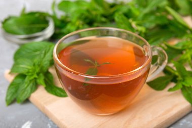 Arka planda bir fincan nane çayı. Fotokopi alanı ile taze nane görünümlü yeşil çay.