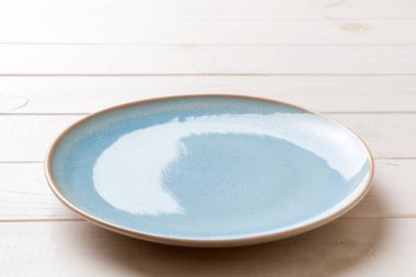 Ahşap zemin üzerinde boş mavi plakanın perspektif görüntüsü. Tasarımın için boş boşluk.