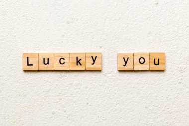 Lucky you word written on wood block. Lucky you text on table for your desing, Top view concept.