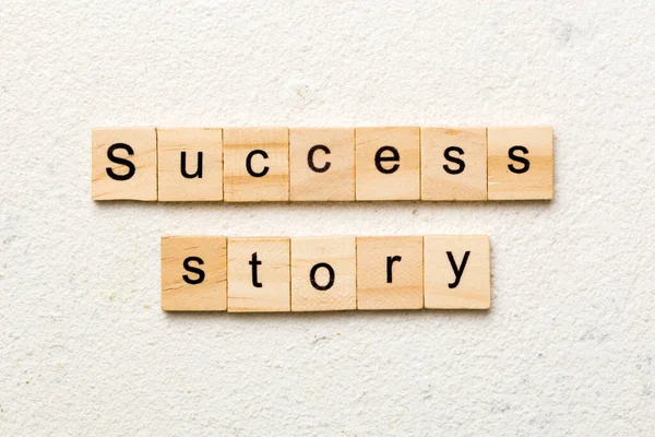 Success story word written on wood block. Success story text on table, concept.