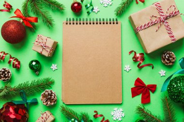 Christmas blank greeting card mock-up scene. Creative layout made of Christmas tree branches and paper card note. Flat lay. Nature New Year concept.