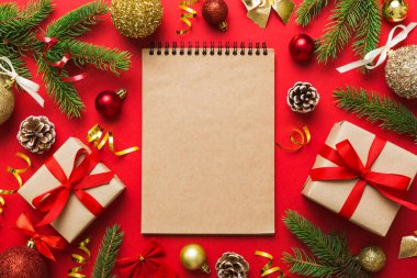 Christmas blank greeting card mock-up scene. Creative layout made of Christmas tree branches and paper card note. Flat lay. Nature New Year concept.