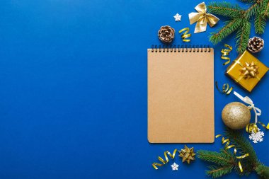 Christmas blank greeting card mock-up scene. Creative layout made of Christmas tree branches and paper card note. Flat lay. Nature New Year concept.