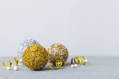 Christmas ball on colored background. decoration bauble with ribbon bow with copy space.