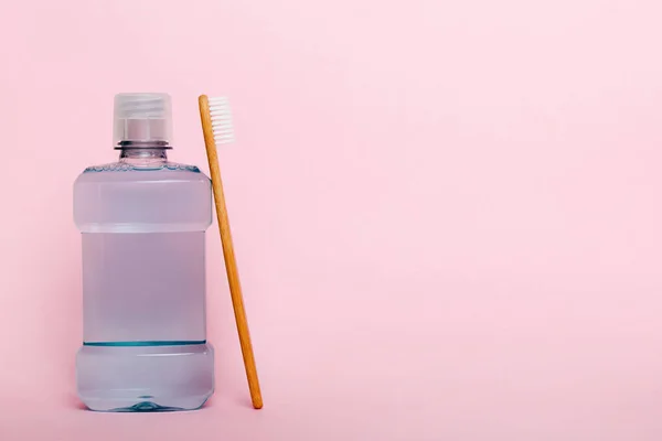 Mouthwash and other oral hygiene products on colored table top view with copy space. Flat lay. Dental hygiene. Oral care products and space for text on light background. concept.