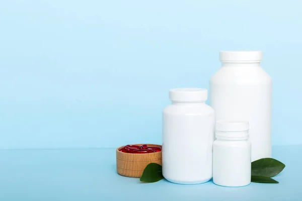 different drugs and health supplement pills with medicine bottle health care and medical top view. Vitamin tablets. Bottle with colored pills on table background. Multivitamins.