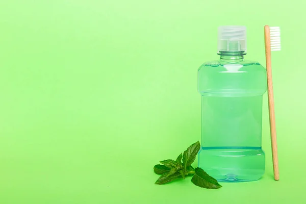 Mouthwash and fresh mint on colored background, top view with copy space for text.