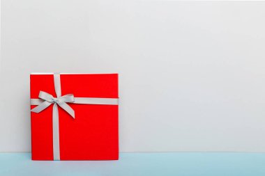 Tatil hediyesi olarak gri kurdeleli üst görünümü fotokopi alanına bağladım. Tatil geçmişi düzdü. Doğum günü ya da Noel hediyesi. Kopya alanı olan Noel hediyesi kutusu konsepti.