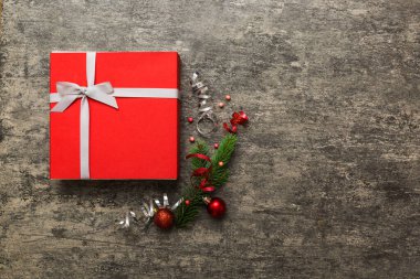 Top view Flat lay Christmas decorations and gift box on colored background with copy space. Christmas or Happy New Year composition.