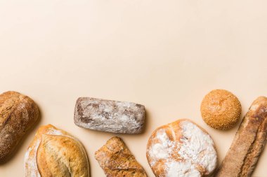Ev yapımı doğal ekmek. Arka plan olarak farklı taze ekmek türleri, kopya alanı ile üst görünüm.
