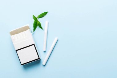 Bir paket mentollü sigara ve renkli masada taze nane şekeri, mentollü sigaralar düz yerde yatıyordu..